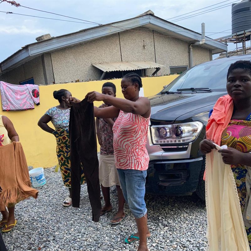 Women collecting donated clothing at a community distribution