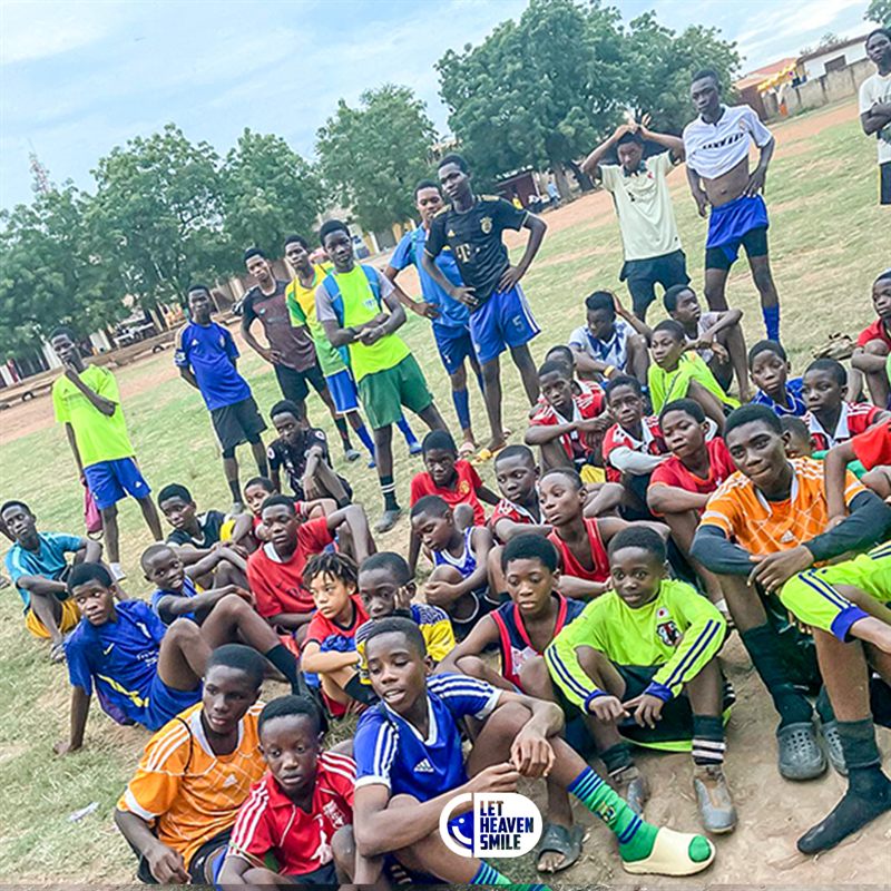 Young footballers gathered together on a pitch at the end of a session