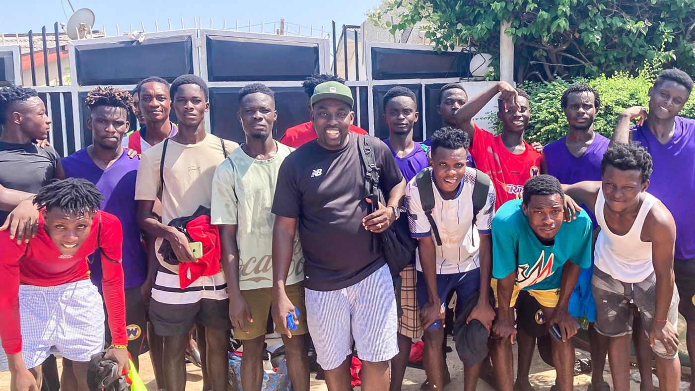 Young people gathered with a coach in Ghana