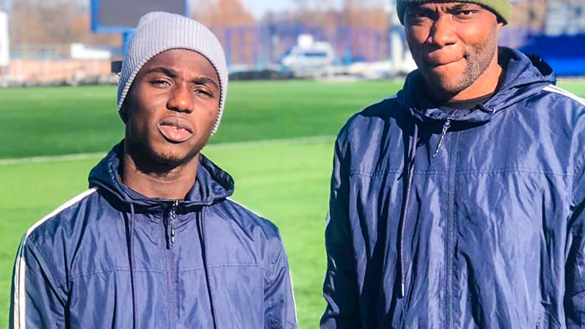 Two young footballers at a training ground overseas